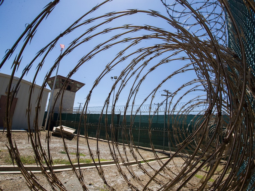 caption: In this photo reviewed by U.S. military officials, the control tower is seen through the razor wire inside the Camp VI detention facility, Wednesday, April 17, 2019, in Guantanamo Bay Naval Base, Cuba.