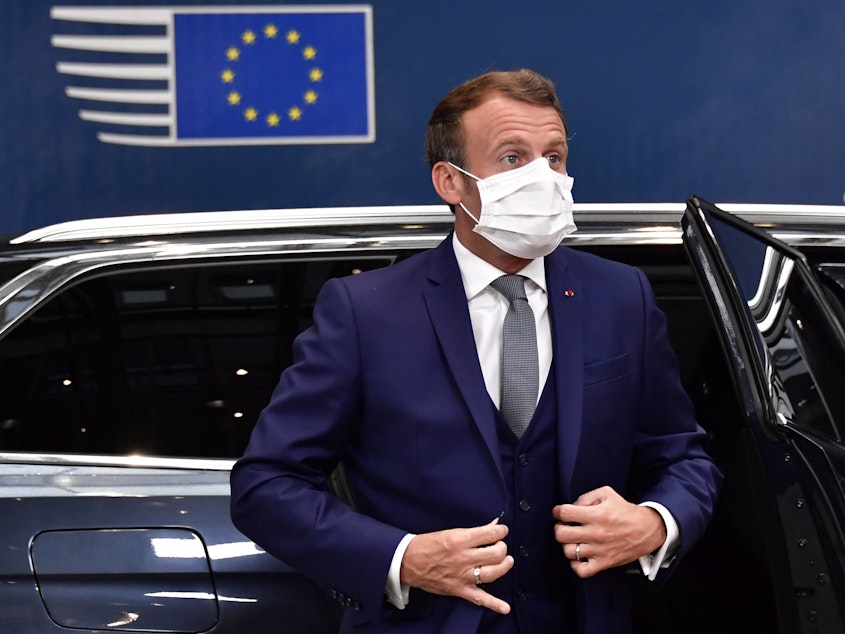 caption: France's President Emmanuel Macron arrives Friday for a European Union meeting in Brussels, where leaders of the 27-member bloc will hold their first face-to-face summit since the pandemic to discuss a COVID-19 economic rescue plan.