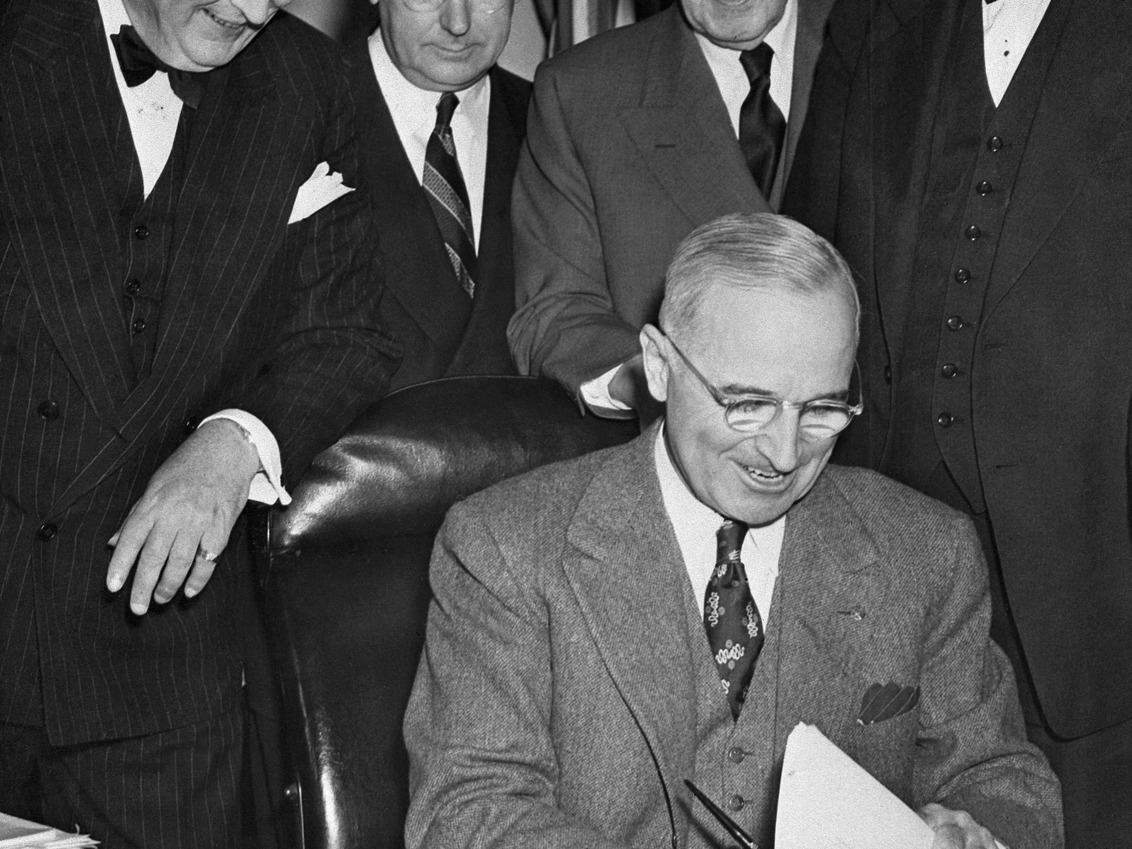 caption: President Harry Truman signs the Marshall Plan on April 3, 1948 in Washington. The plan played a key role in the reconstruction of Europe after World War II and was part of the wide-ranging moves by the U.S. to establish a new international order that still defines the world to this day.