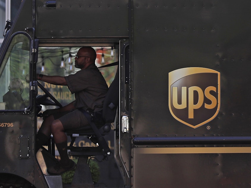 caption: A UPS driver stops at a traffic light on April 24 in St. Louis. UPS employees are now allowed to grow their beards as the company loosens up on its appearance rules.