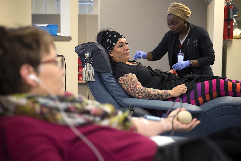 caption: Lisa Ferguson gives blood on Monday, December 18, 2017, at Cascade Regional Blood Services in Puyallup.