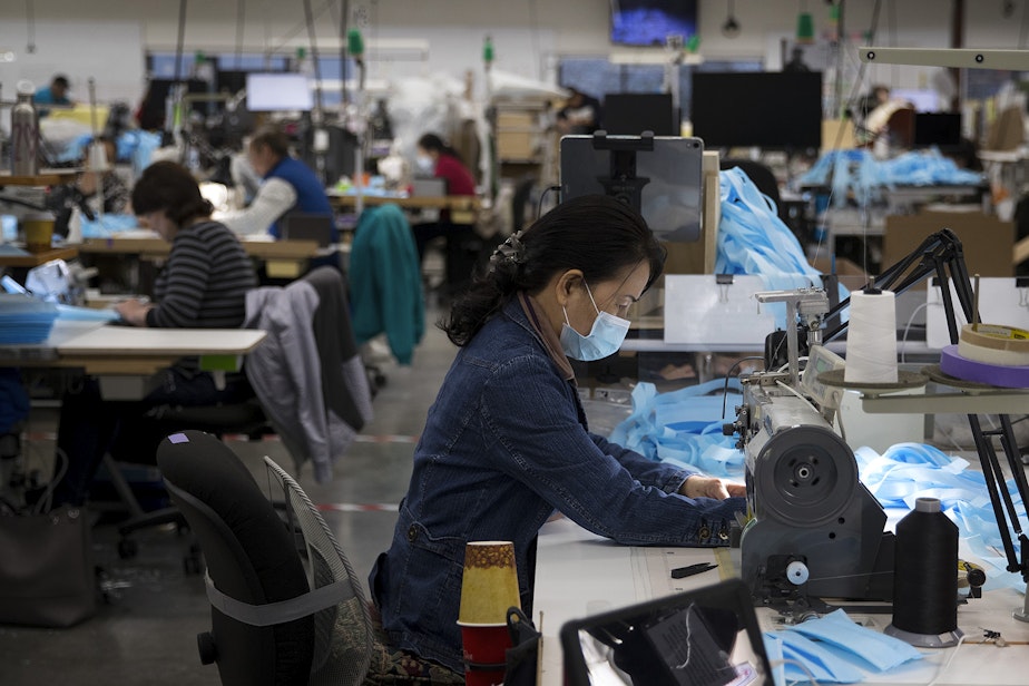 caption: Kaas Tailored employees sew masks on Monday, March 23, 2020, at the Kaas Tailored furniture factory in Mukilteo. 