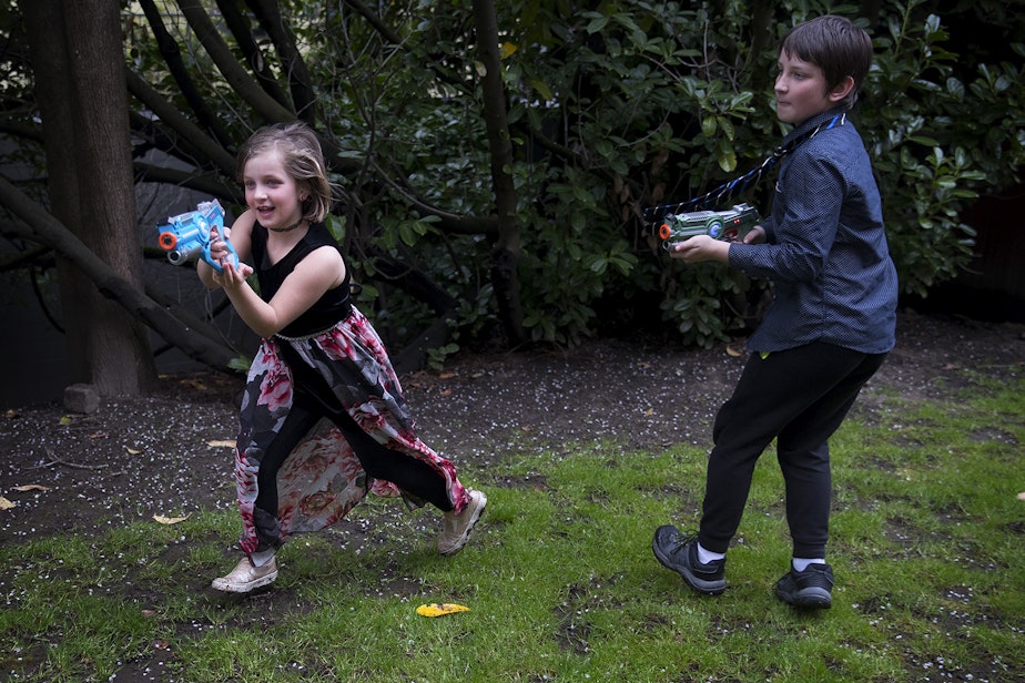caption: Amaleia McCarty, 8, left, and Xaven McCarty, 11, play laser tag during Xaven's birthday party on Sunday, April 7, 2019, at their home in Seattle. 