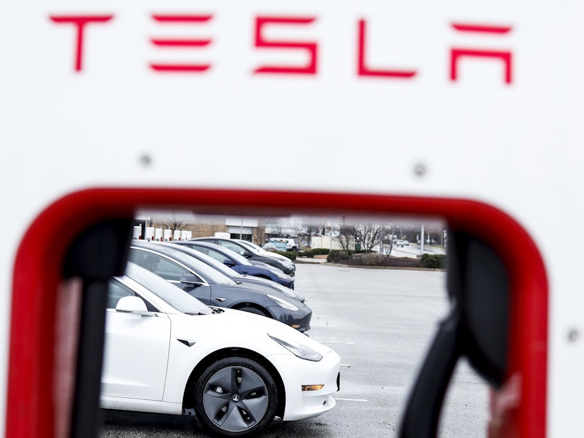 caption: A Tesla charging station stands in a parking lot in Springfield, Va., on Jan. 17. The automaker decreased the prices of Teslas by up to 20%, a move seen as a reaction to competition in the global market for electric vehicles and rising inflation rates.