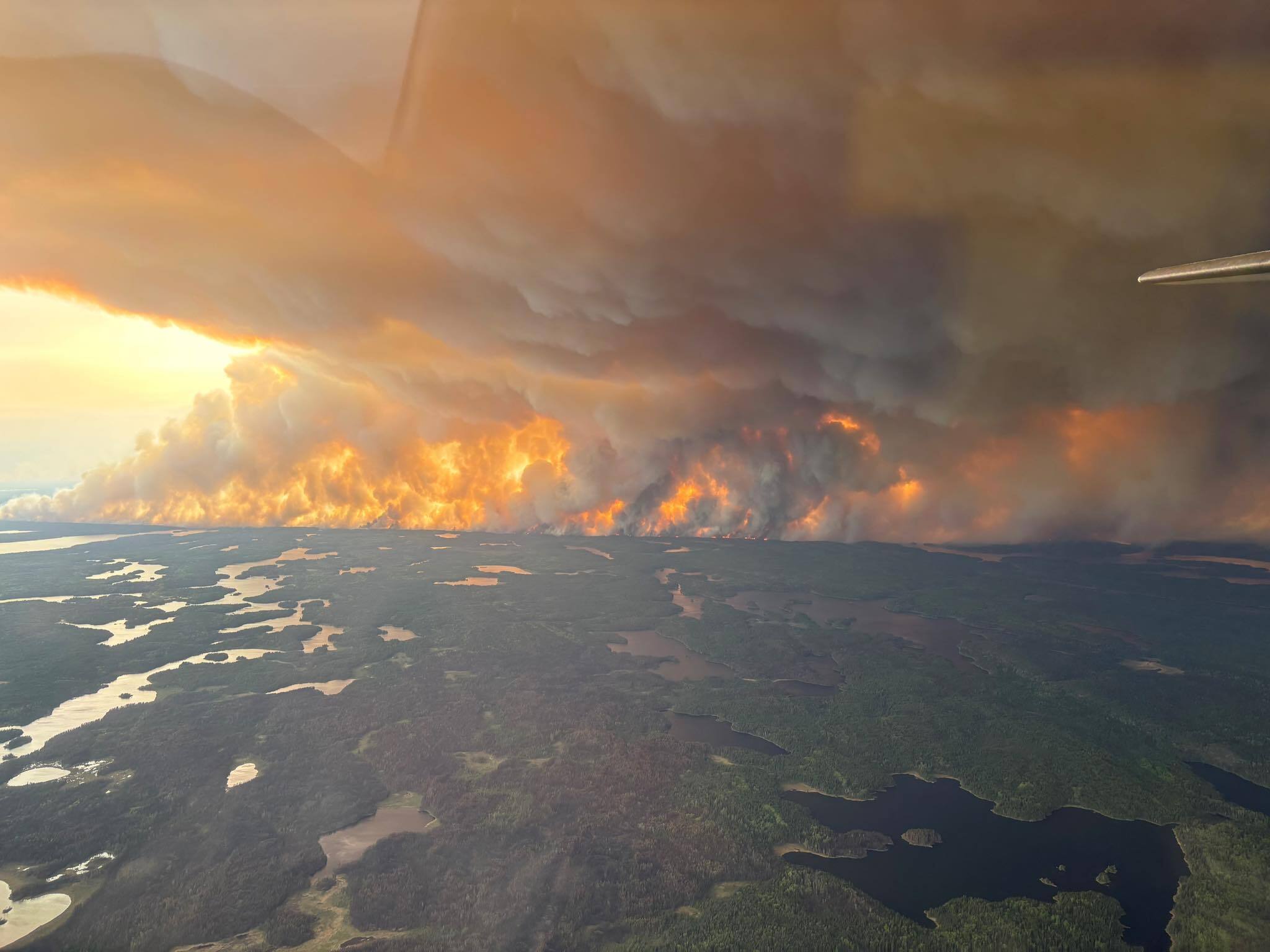 caption: Clouds of wildfire smoke like this one in Flin Flon, Manitoba, are wafting into the Northern Plains and Midwest.