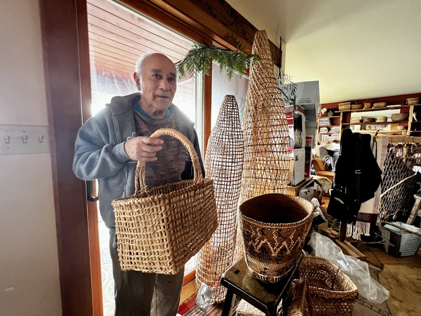 caption: Carriere with a variety of his baskets, including some towering salmon baskets.