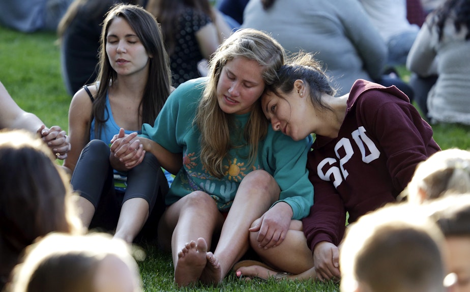 caption: SPU students pray and comfort each other after last Thursday's campus shootings.