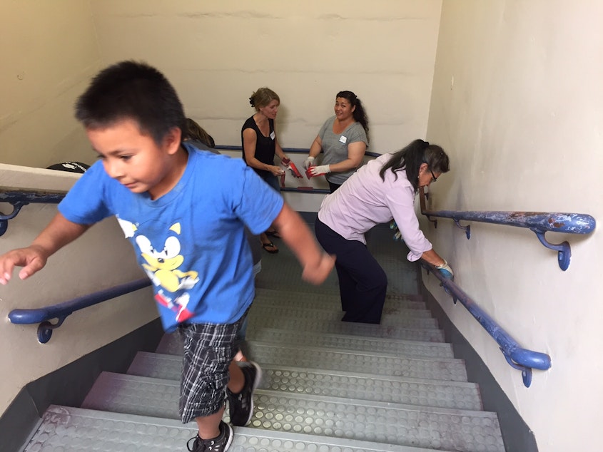 caption: Families at Rainier Prep, a charter school, at a work party last summer.