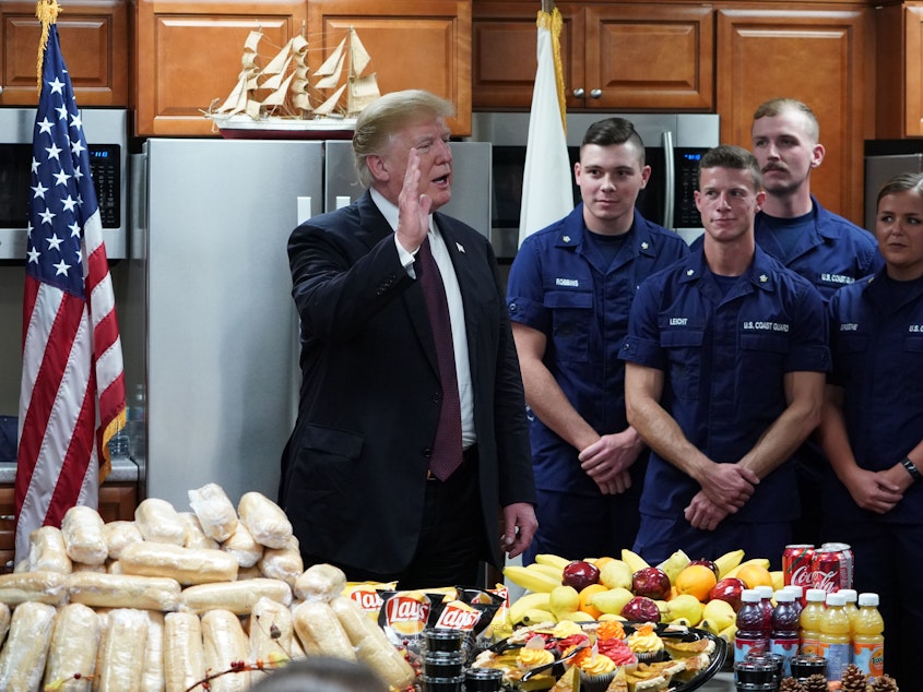 caption: President Trump visits U.S. Coast Guard personnel in Florida on Thanksgiving Day.