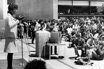 caption: Shirley Chisholm, the first Black woman elected to U.S. Congress was running for president in 1972 when she had a remarkable interaction with the pro-segregation George Wallace, then governor of Alabama. Her efforts to build bridges with him ultimately changed his point of view. She's pictured here giving a speech at Laney Community College during her presidential campaign.