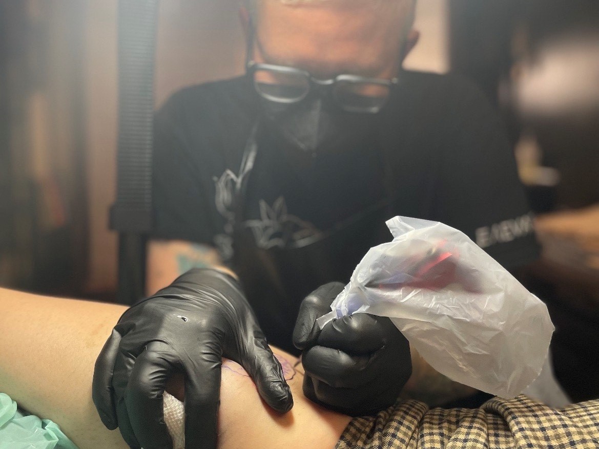 caption: Tattoo artist Cedre Csillagi has completed 11 of what will eventually be 1,000 pansy tattoos.