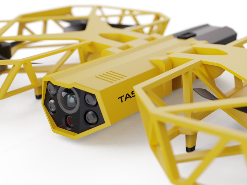 caption: This photo provided by Axon Enterprise depicts a conceptual design through a computer-generated rendering of a taser drone.