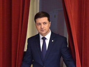 caption: Volodymyr Zelenskiy enters a hall in Kyiv on March 6 to take part in the taping of the television series <em>Servant of the People. </em>His role on the show was as a fictional president of Ukraine.