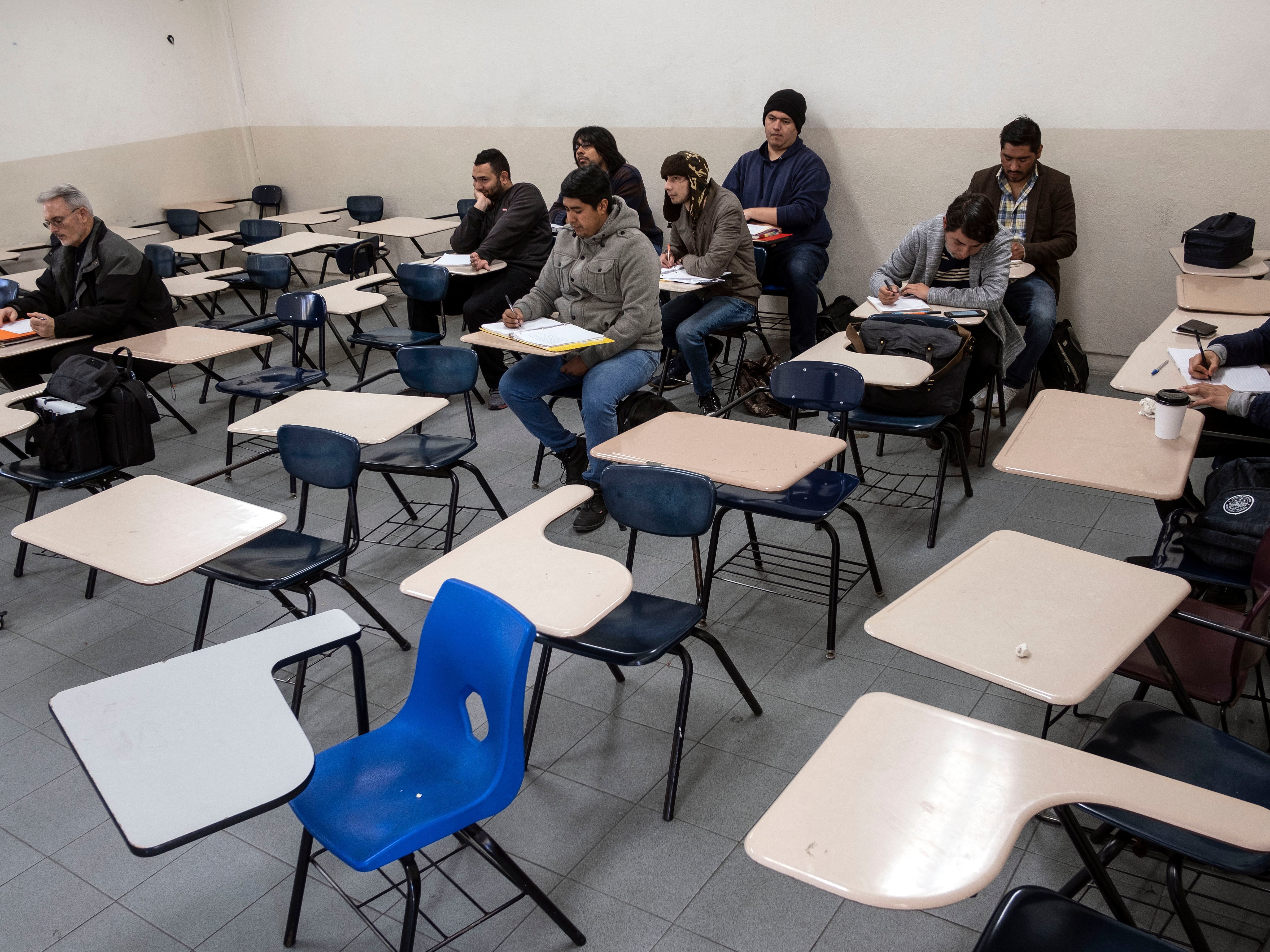 caption: Male students attend to class during at the Universidad Autonoma de Baja California in Tijuana. Women were largely absent from classes in photos posted on social media.