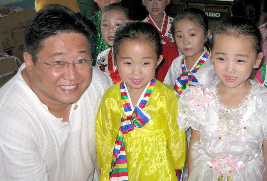 caption: Kenneth Bae poses with North Korean children before being imprisoned by the government there. He was released Saturday after two years in custody.