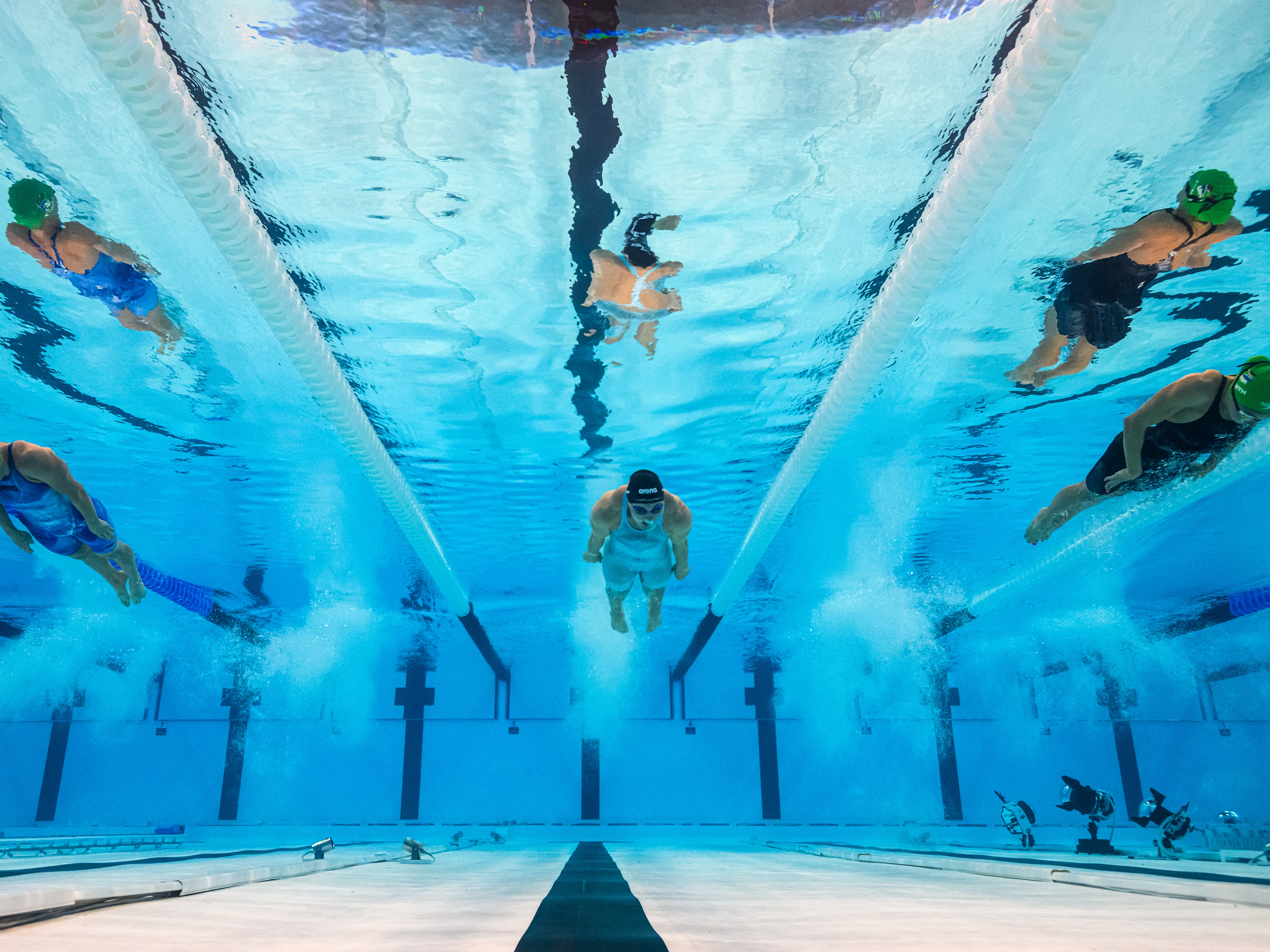 caption: Is the depth of the Paris Olympics pool preventing world records from being broken? Here, an underwater view shows (from left) South Africa's Kaylene Corbett, Ireland's Mona McSharry and South Africa's Tatjana Smith competing in a heat of the women's 200m breaststroke swimming event during the Paris 2024 Olympic Games in Nanterre, west of Paris, on July 31.