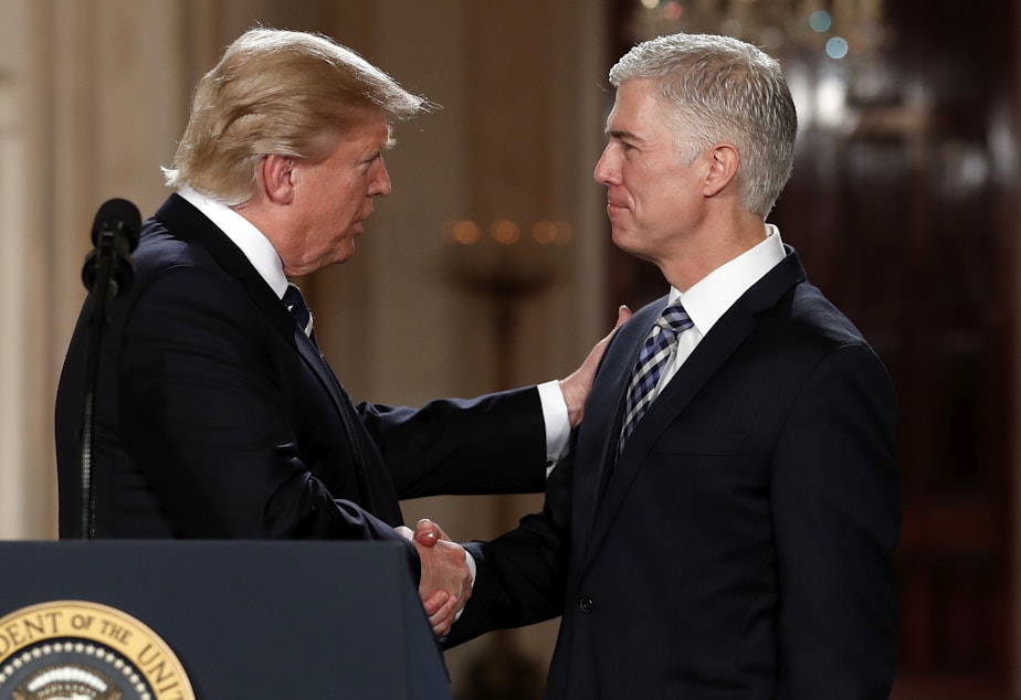 caption: President Donald Trump shakes hands with appeals court Judge Neil Gorsuch, his choice for Supreme Court associate justice in the East Room of the White House in Washington, Tuesday, Jan. 31, 2017.