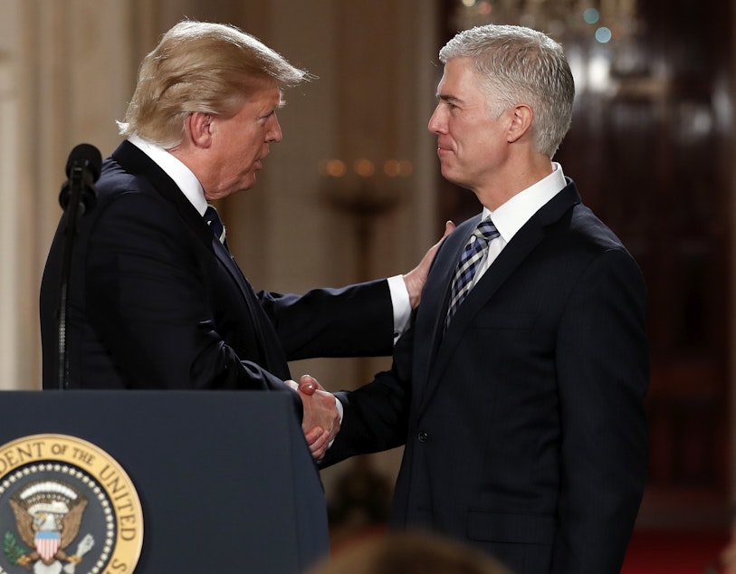 caption: President Donald Trump shakes hands with appeals court Judge Neil Gorsuch, his choice for Supreme Court associate justice in the East Room of the White House in Washington, Tuesday, Jan. 31, 2017. 