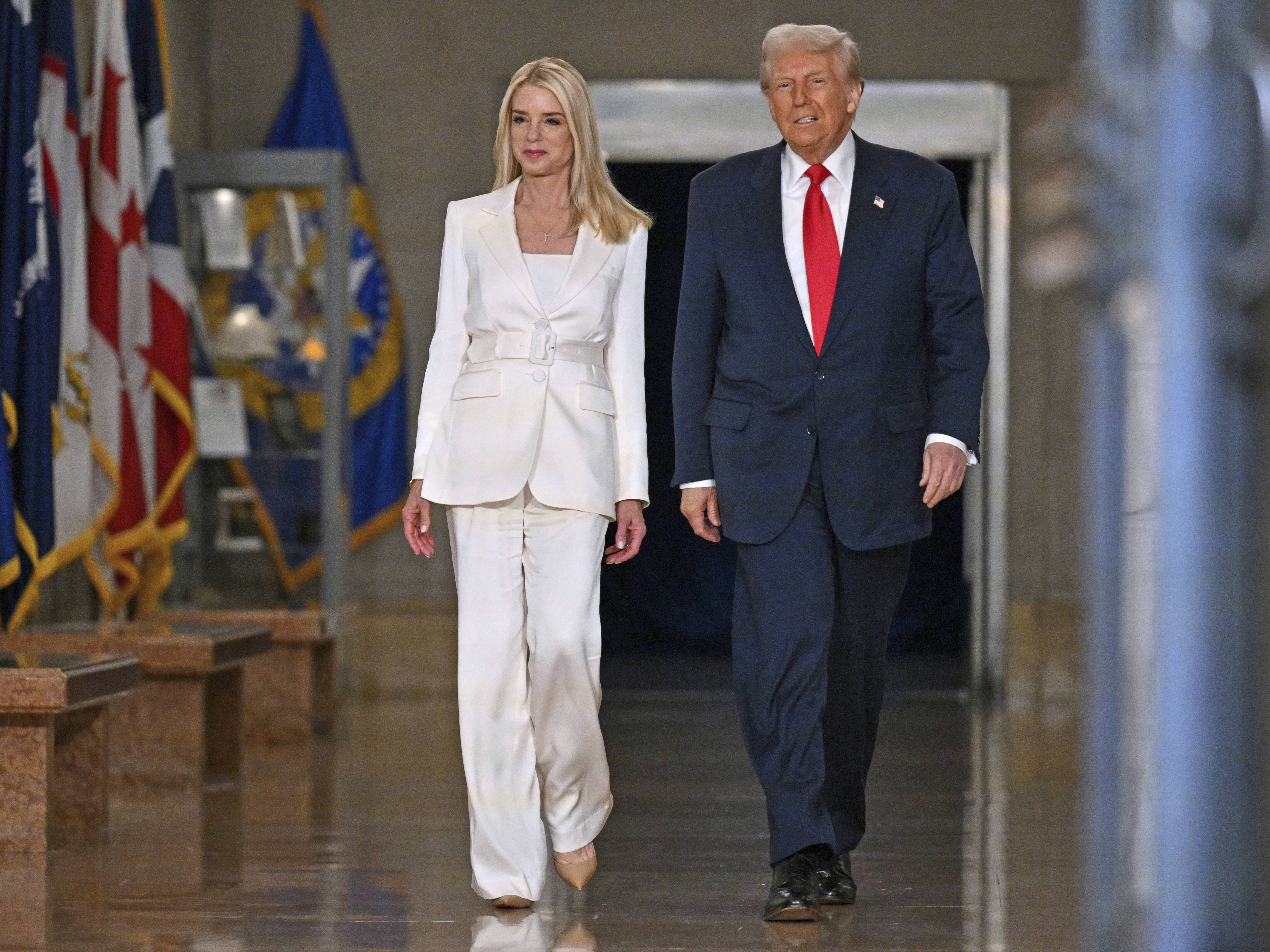 caption: President Trump arrives with Attorney General Pam Bondi to speak at the Justice Department on March 14.