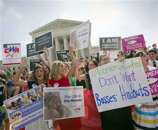 caption: This photo taken June 30, 2014, shows demonstrators reacting outside the Supreme Court in Washington after hearing the court's decision on the Hobby Lobby case.