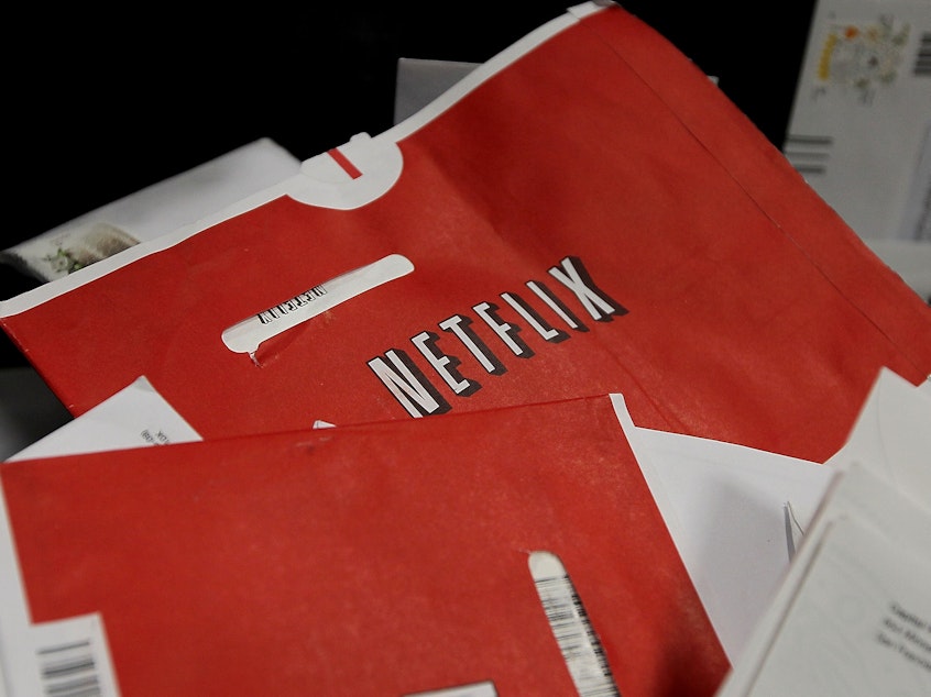 caption: Red Netflix envelopes sit in a bin of mail at the U.S. Post Office sort center March 30, 2010 in San Francisco, California. The company is ending its DVD mailing service with a promotion.