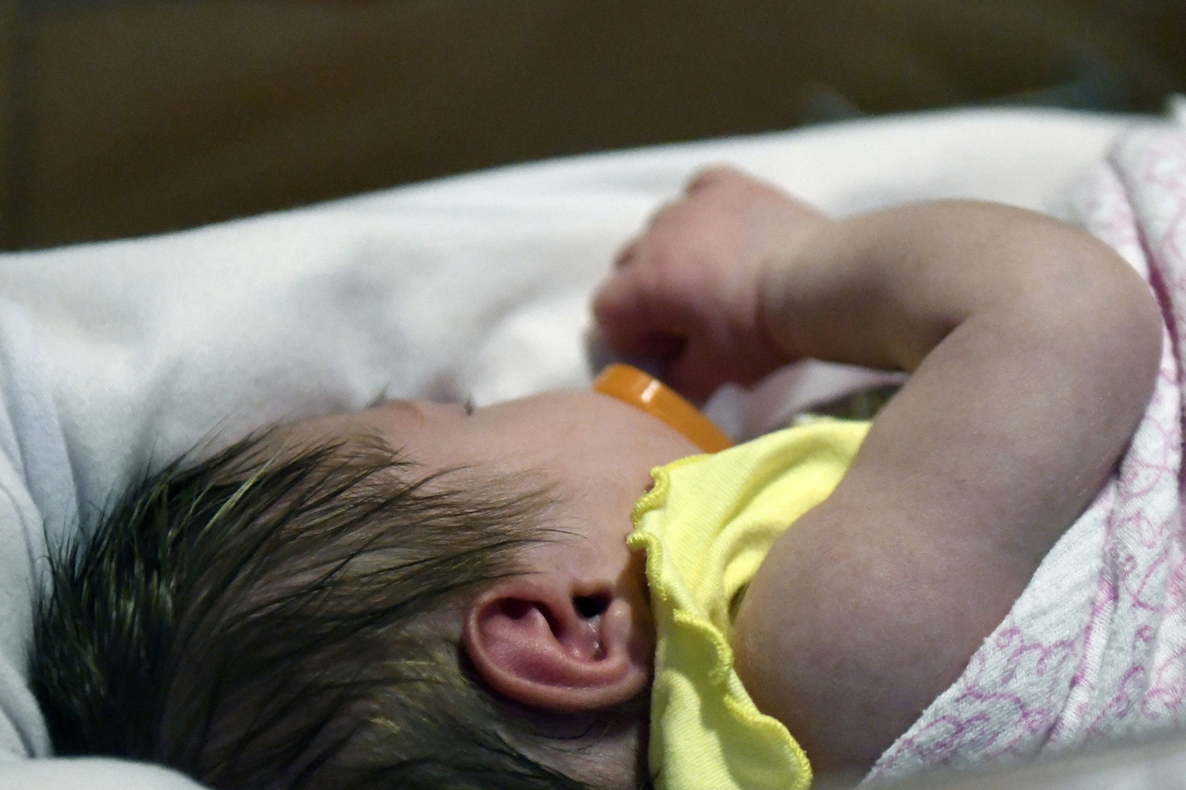 caption: A week-old baby lies in a neonatal intensive care unit bay at the Norton Children's Hospital in Louisville, Ky. (Timothy D. Easley/AP)