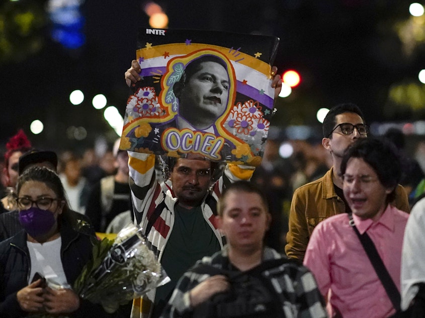 caption: Demonstrators march with a picture of Aguascalientes state electoral court magistrate Jesus Ociel Baena in Mexico City, Monday, Nov. 13, 2023.