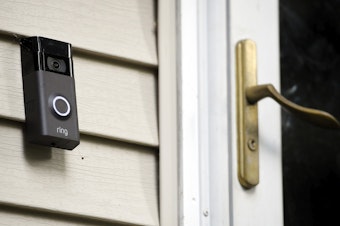 caption: A Ring doorbell camera is seen outside a home in Wolcott, Conn., on July 16, 2019. Amazon-owned Ring said it will stop allowing police departments to request doorbell camera footage from users, marking an end to a feature that has drawn criticism from privacy advocates.