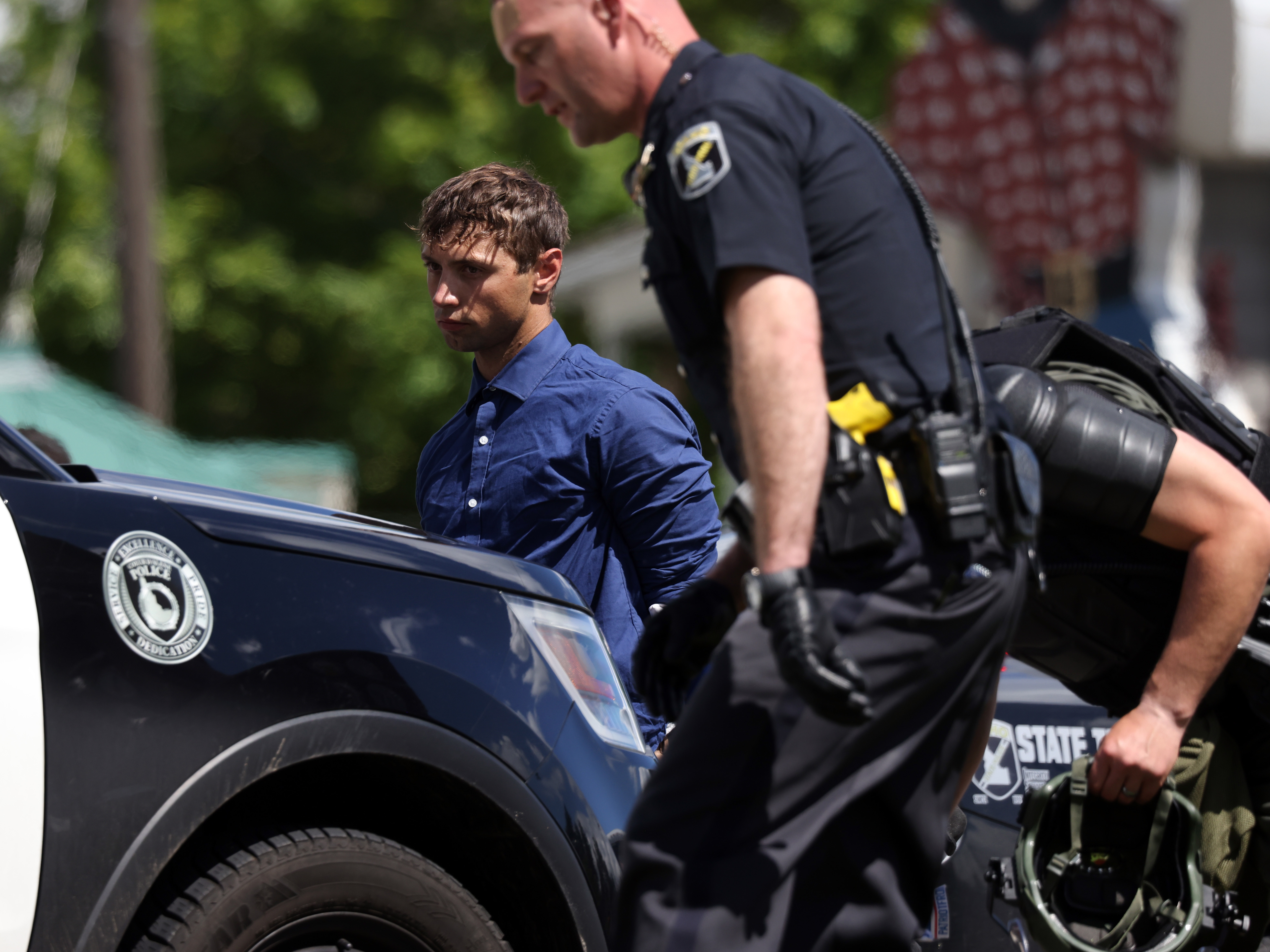 caption: Law enforcement detains 31 members of the white nationalist group Patriot Front after they were removed from a U-Haul truck near the LGBTQ+ community's "Pride in the Park" event in Coeur d'Alene, Idaho on June 11, 2022.