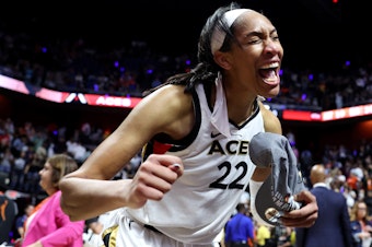 caption: A'ja Wilson of the Las Vegas Aces celebrates after defeating the Connecticut Sun to win the 2022 WNBA Finals.