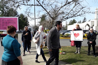 caption: A small crowd gathers to support worshipers as they leave prayers at the Muslim Association of Puget Sound in Redmond on Friday, March 15, 2019.