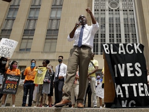 caption: Mayor Quinton Lucas talks to demonstrators during a rally in Kansas City, Mo., on June 5, to protest the death of George Floyd.