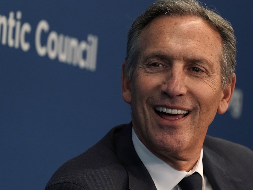 caption: Former Starbucks CEO Howard Schultz participates in a discussion at the Atlantic Council in May 2018.