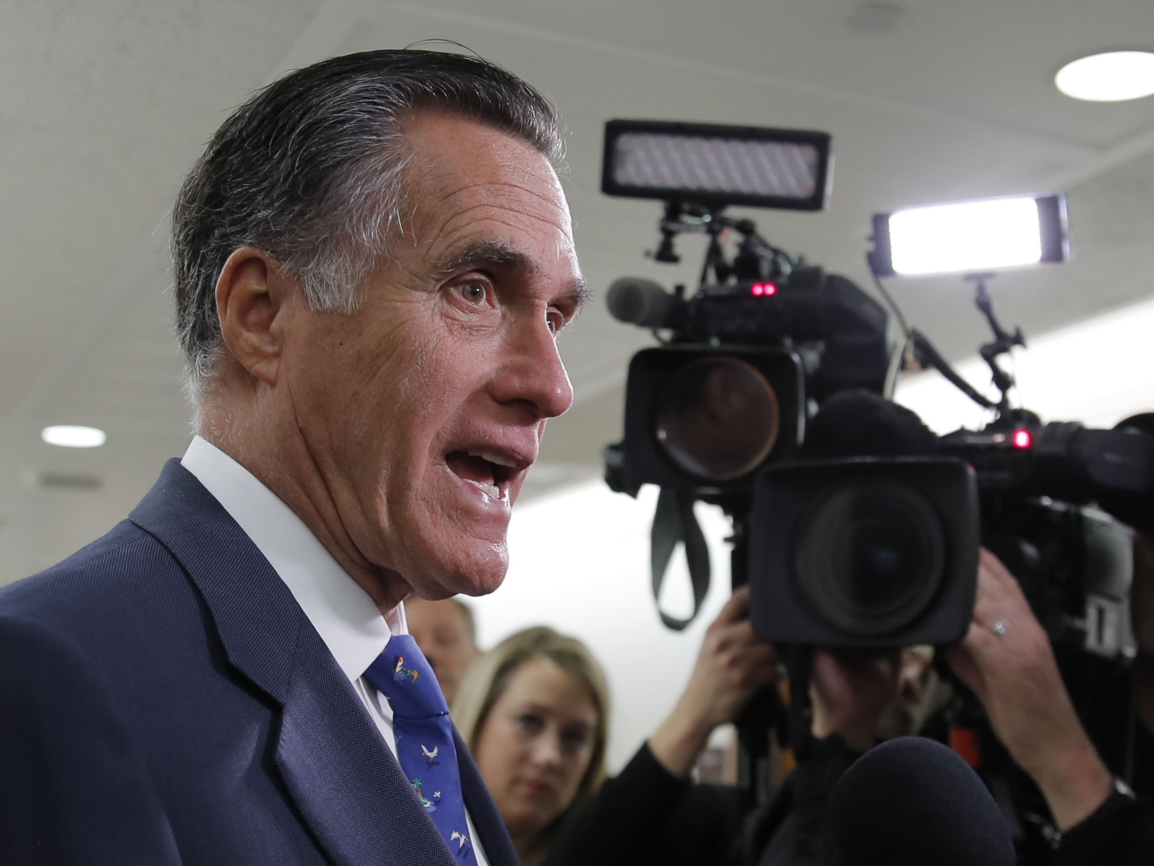 caption: Sen. Mitt Romney is proposing a temporary pay bonus — up to $12 an hour — for front-line employees during the COVID-19 pandemic. The increase would be paid, in part, by employers and offset via a payroll tax credit.