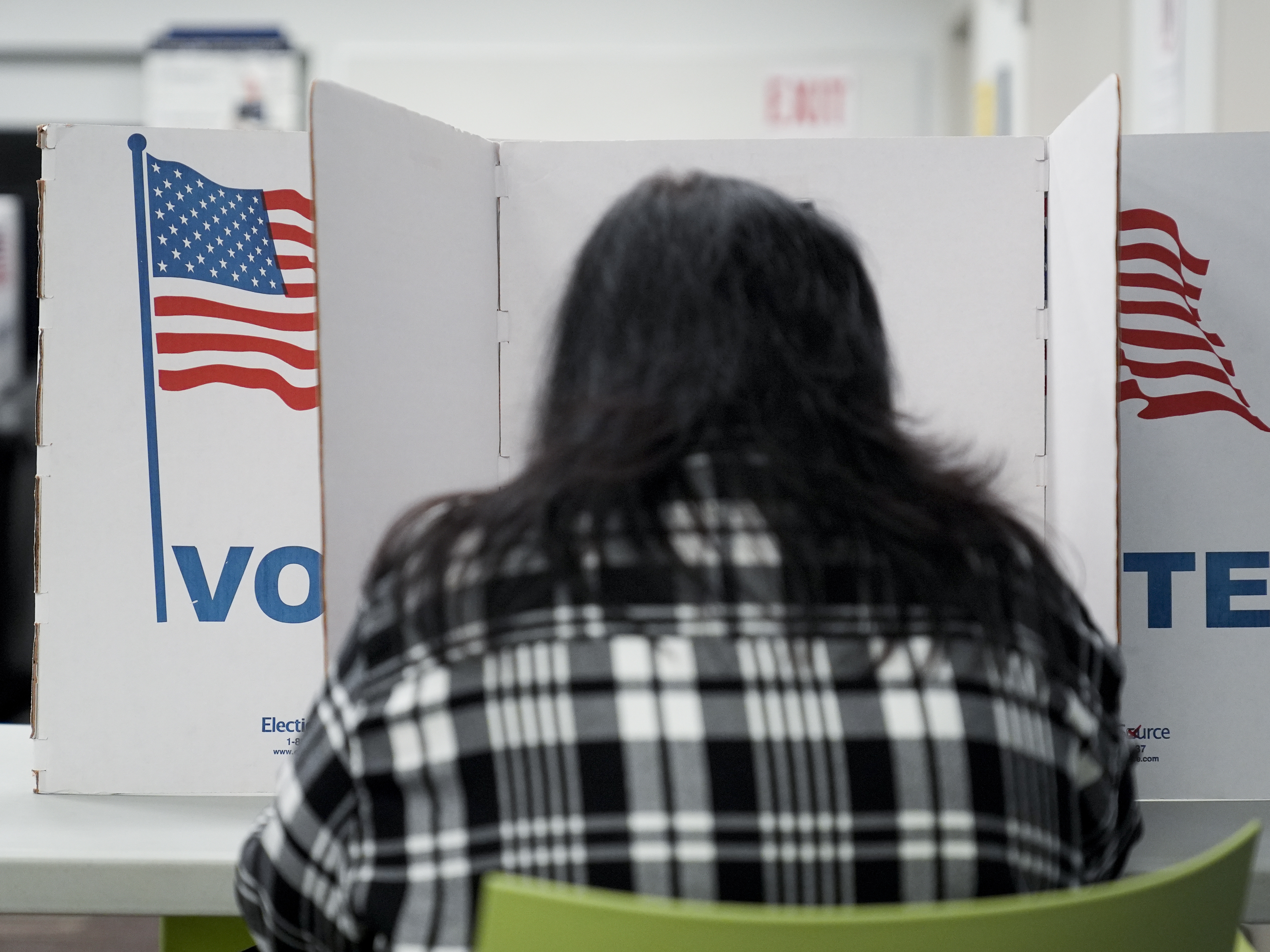 caption: A person marks their ballot at a polling place in Falls Church, Va., during early voting for the 2024 election.