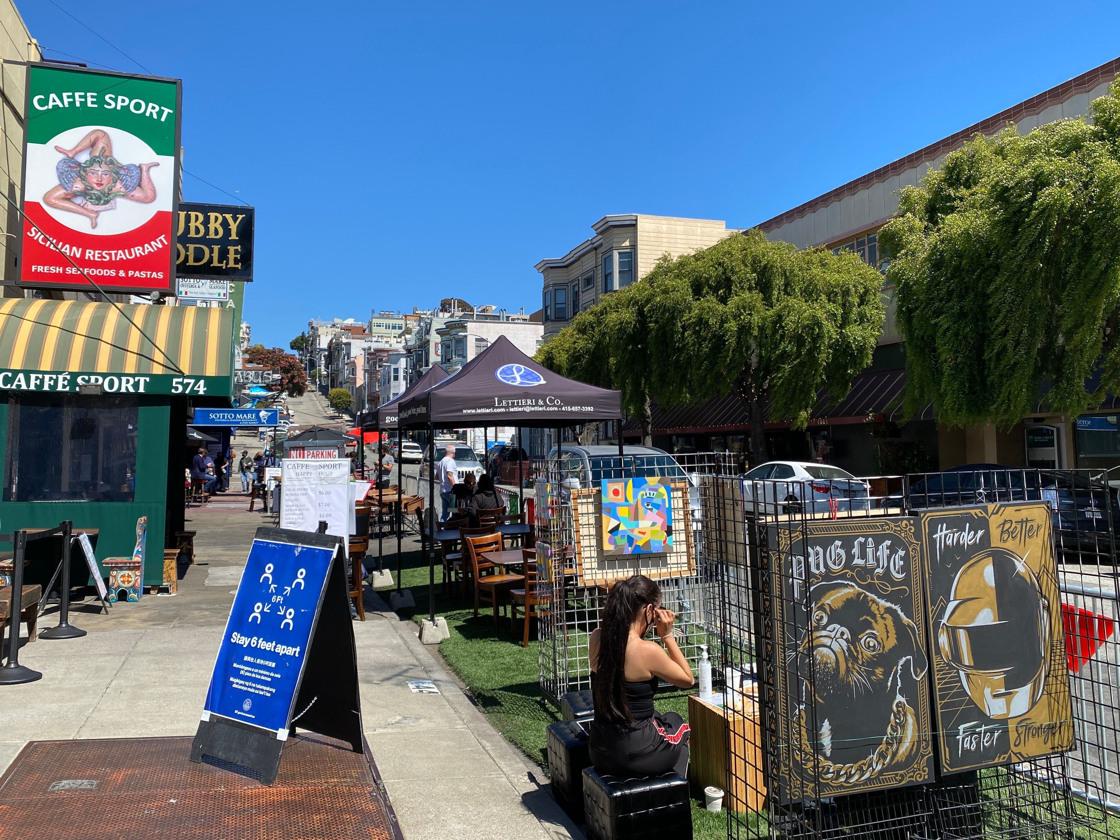 caption: Little Italy neighborhood of San Francisco, July 2020. The city will relax coronavirus restrictions Wednesday, including the reopening of indoor dining and fitness facilities.