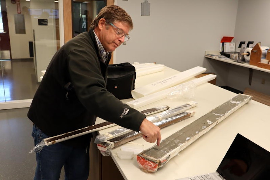 caption: Oregon State University marine geologist Chris Goldfinger shows an offshore sediment core, fat tube on right, and skinnier cores from Pacific Northwest lake bottoms, all of which contain traces of ancient earthquakes.
