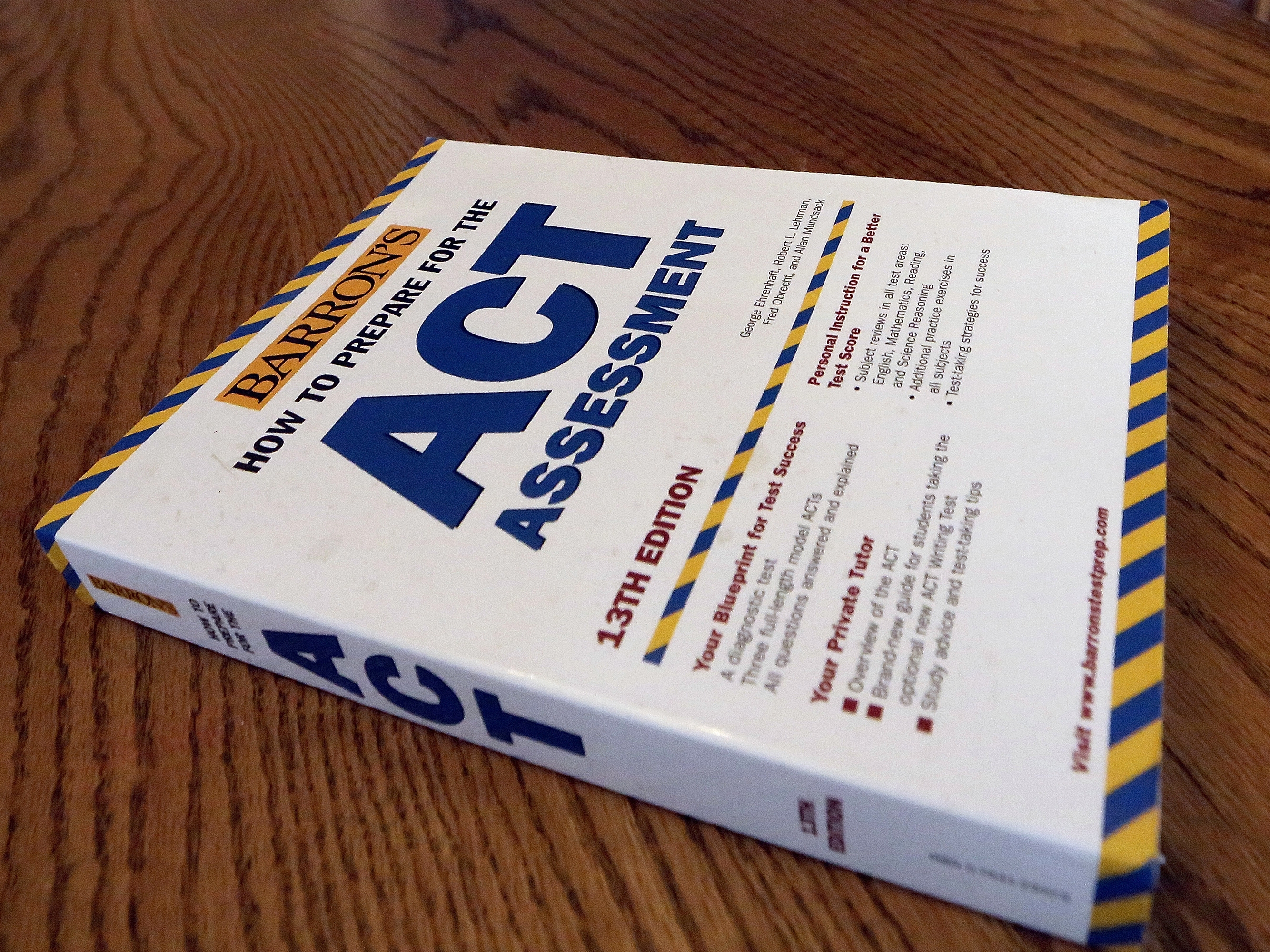 caption: An ACT Assessment preparation book is seen in 2014 in Springfield, Ill. 