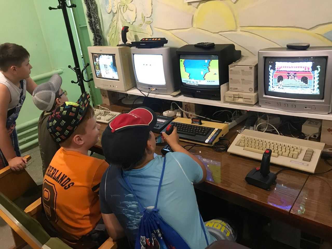 caption: Kids play on retro computers in the IT 8-bit museum in Mariupol, Ukraine before it was attacked.