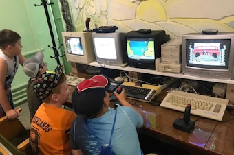 caption: Kids play on retro computers in the IT 8-bit museum in Mariupol, Ukraine before it was attacked.