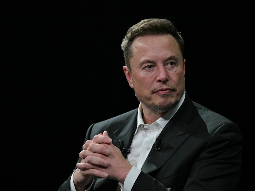 caption: Elon Musk looks on during his visit to the Vivatech technology startups and innovation fair at the Porte de Versailles exhibition center in Paris on June 16.