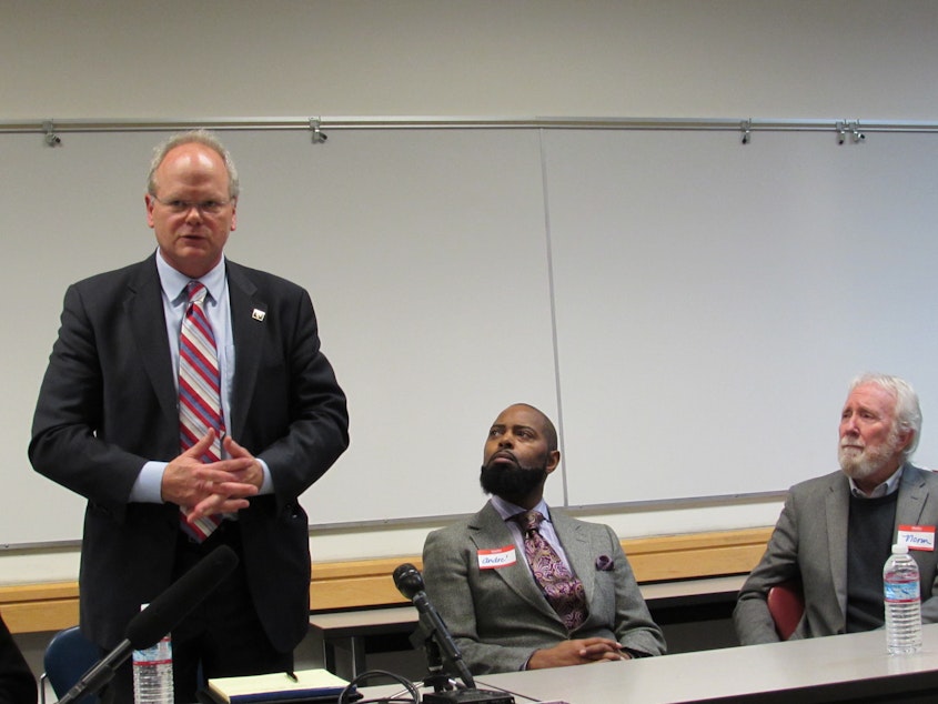 caption: Dan Satterberg (left), Andre Tayor (brother of Che Taylor who was fatally shot by police), and former SPD Chief Norm Stamper at a community meeting.