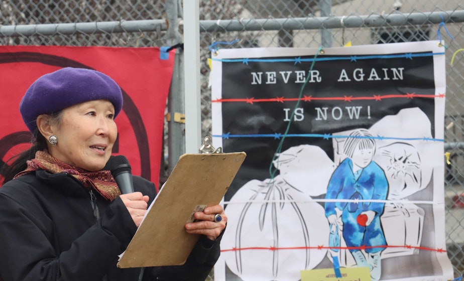 caption: Margaret Sekijima addresses the crowd at the Northwest Detention Center in Tacoma on the Day of Remembrance in 2022. Several of Sekijima's relatives were incarcerated in the Minidoka, Heart Mountain, Tule Lake and Topaz relocation centers.