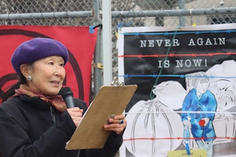 caption: Margaret Sekijima addresses the crowd at the Northwest Detention Center in Tacoma on the Day of Remembrance in 2022. Several of Sekijima's relatives were incarcerated in the Minidoka, Heart Mountain, Tule Lake and Topaz relocation centers.