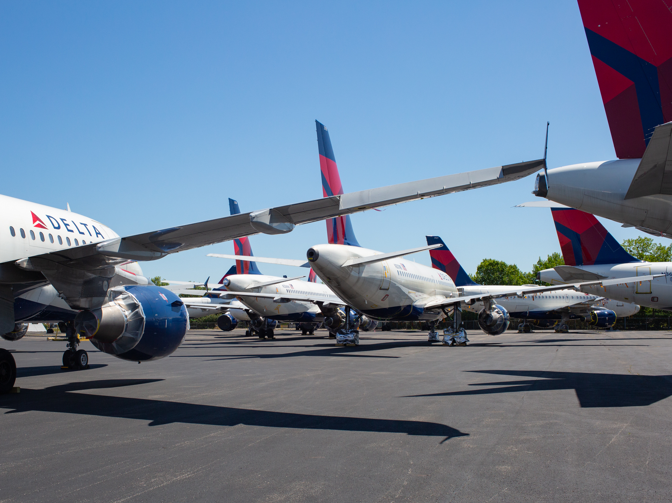 caption: As passenger demand slumped because of the coronavirus pandemic, Delta parked dozens of unneeded jets at the Birmingham-Shuttlesworth International Airport in Alabama in May.