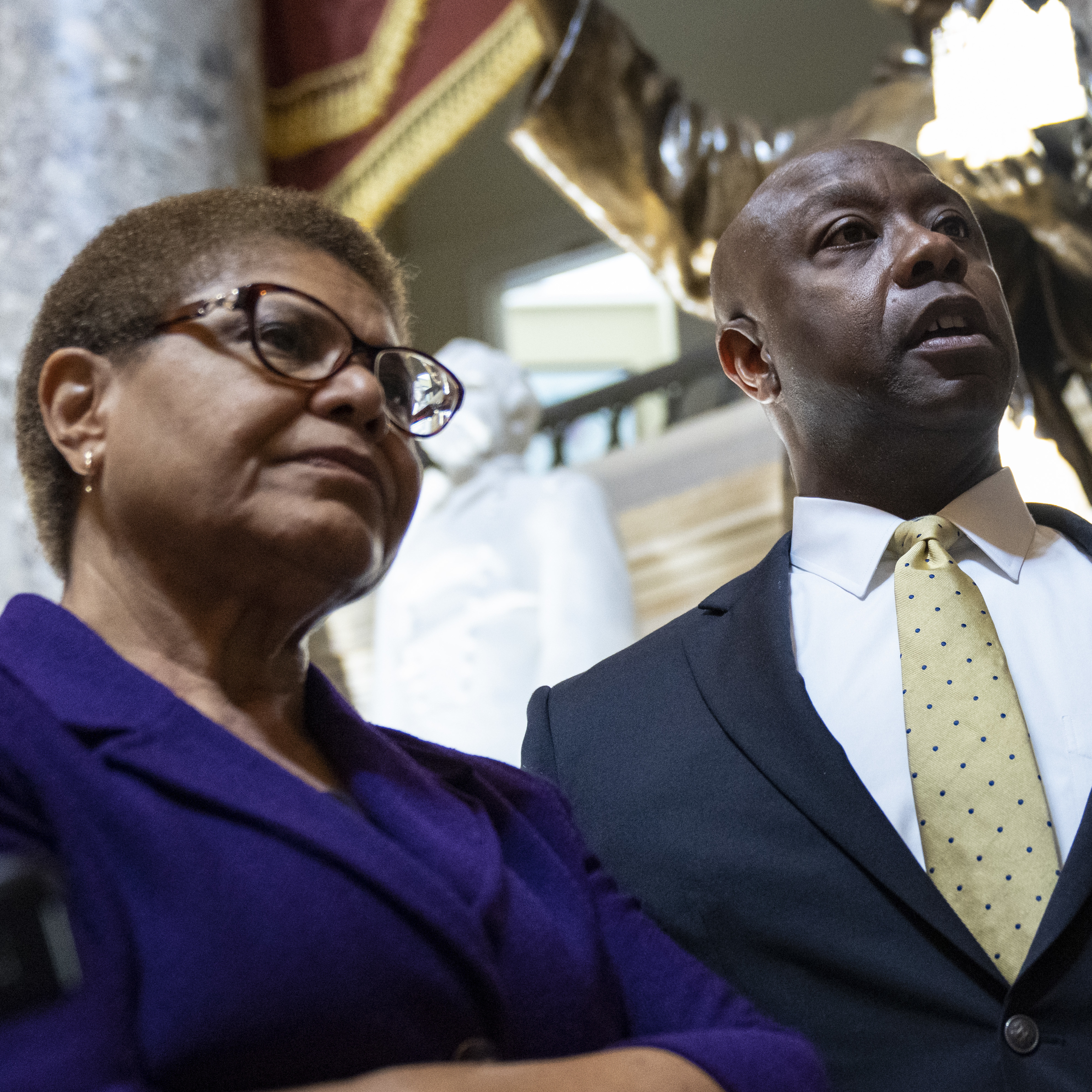 caption: Rep. Karen Bass, D-Calif., Sen. Tim Scott, R-S.C., and Sen. Cory Booker, D-N.J., speak to reporters following a May meeting about police reform legislation. The trio announced a tentative deal Thursday evening.