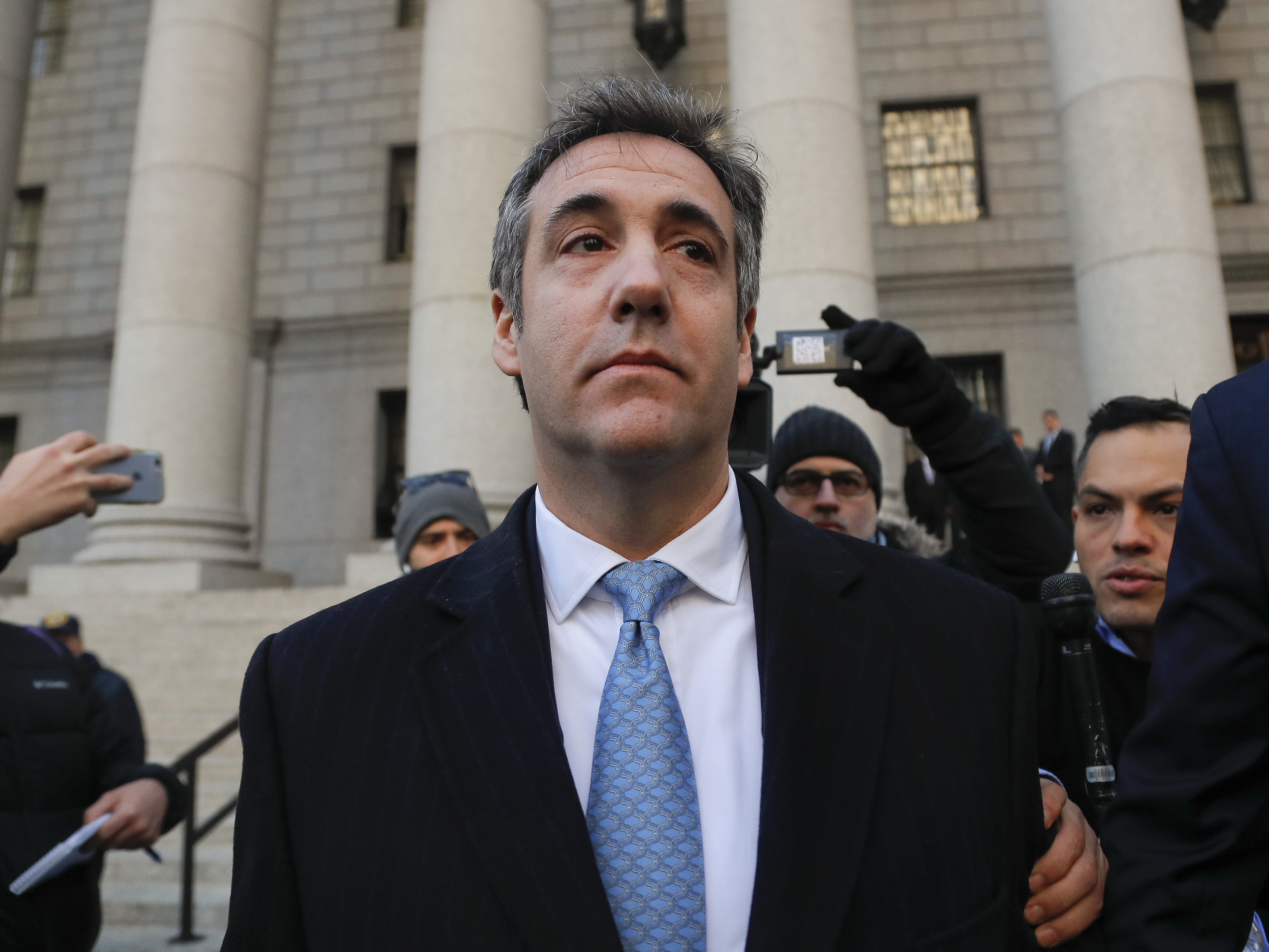caption: Michael Cohen walks out of federal court Thursday in New York, after pleading guilty to lying to Congress about work he did on an aborted project to build a Trump Tower in Russia.
