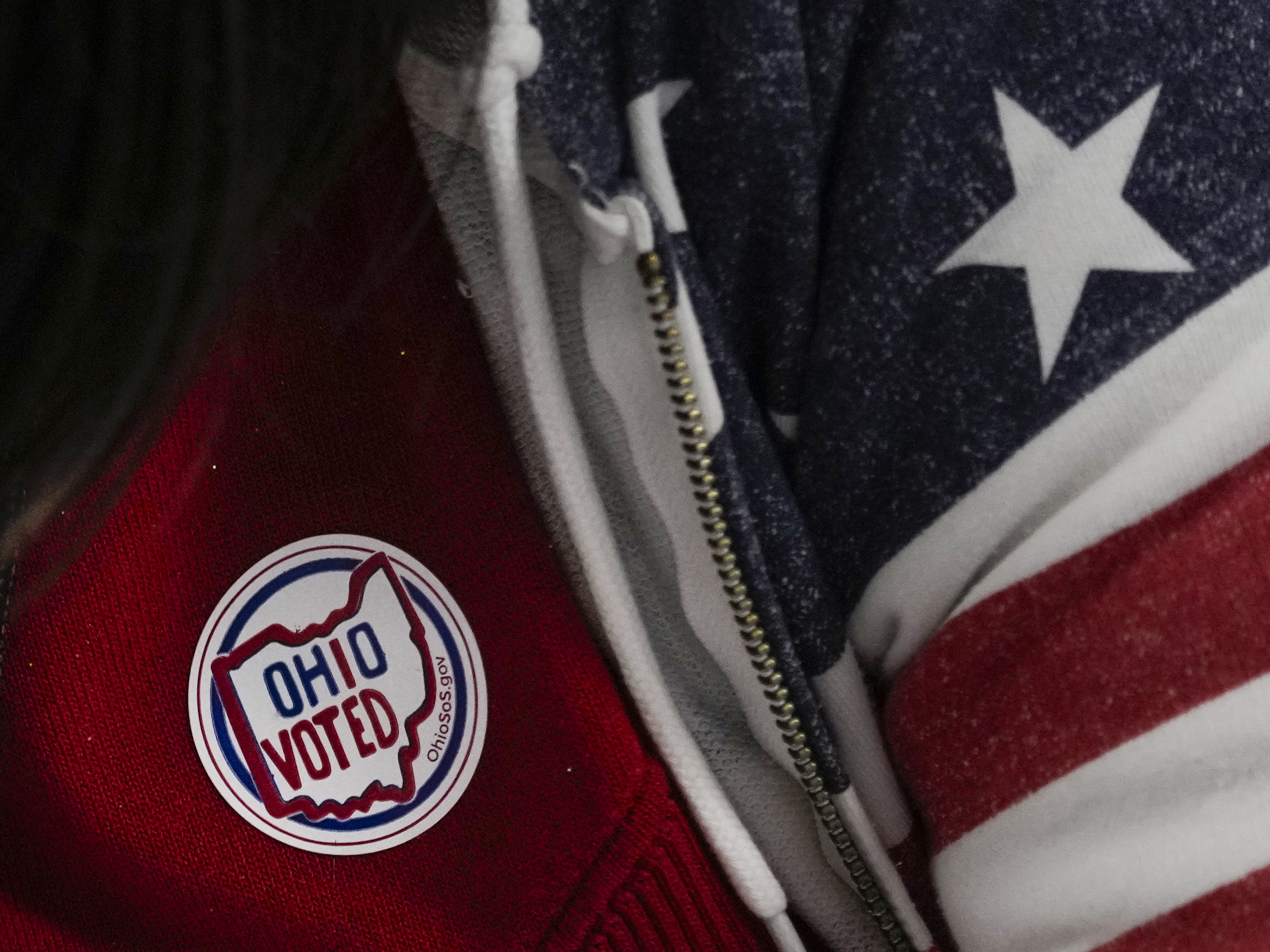 caption: A poll worker has an "Ohio Voted" sticker on her shirt during early in-person voting at the Hamilton County Board of Elections in Cincinnati on Oct. 11. Ohio has a constitutional amendment before voters this year that would include reproductive health protections in the state's constitution, including abortion rights.