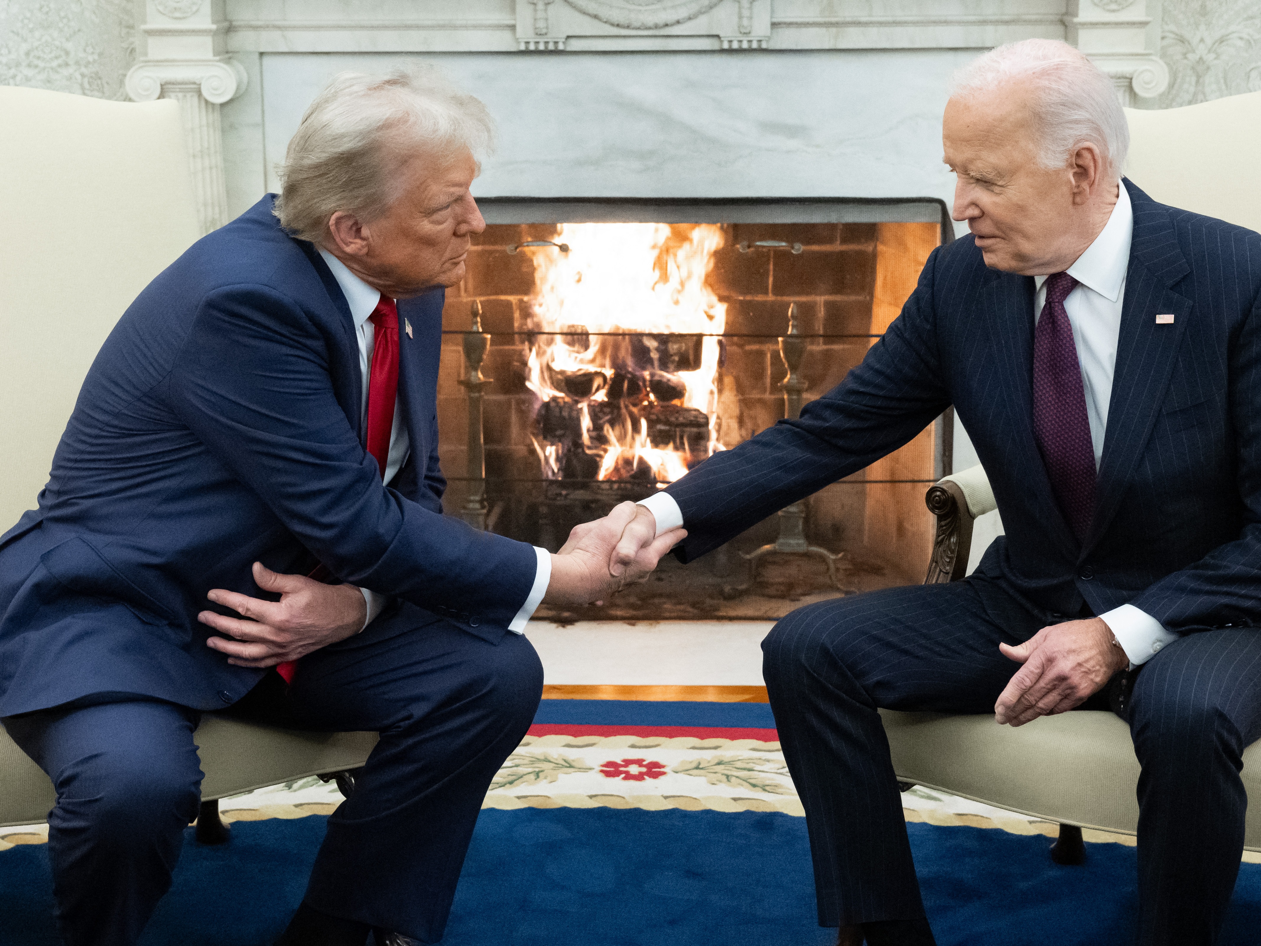 caption: President Biden shakes hands with President-elect Donald Trump during a meeting in the Oval Office on Nov. 13, 2024.