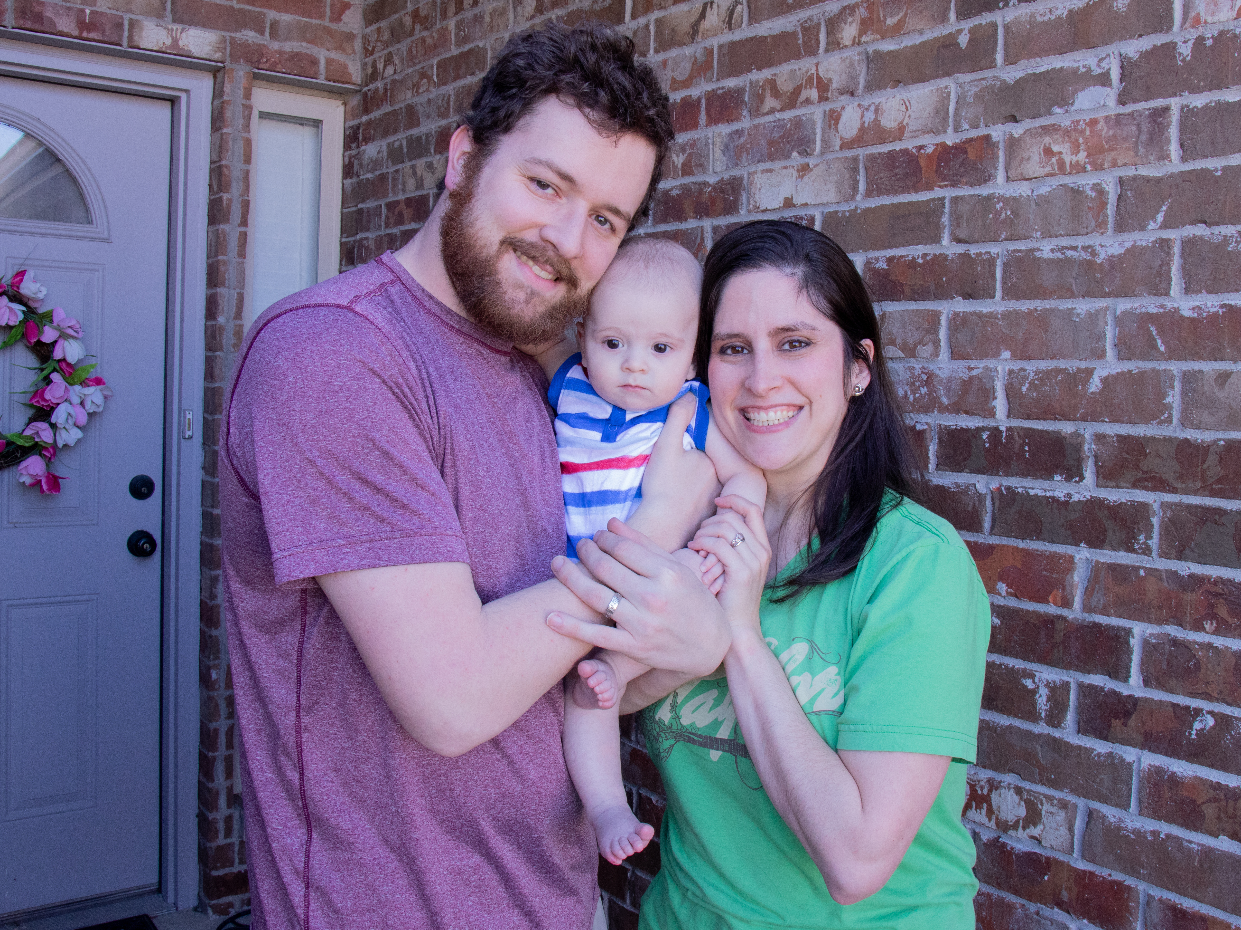 caption: Teacher Karli Myers poses with her husband, Jordan Myers, and their seven-month-old, Luke. Karli spent years stockpiling sick leave in order to have time at home with Luke after he was born.